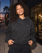 NAMAI Signature Vintage Hoodie — Black Rock — female model, vintage campaign mockup (AI-generated)